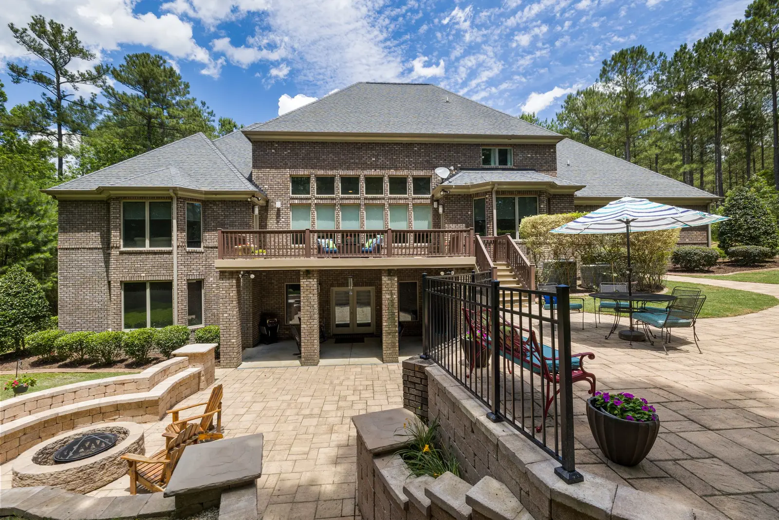 Ashlar slate pattern stamped concrete patio beside a brick home in Cedar Hill, TX