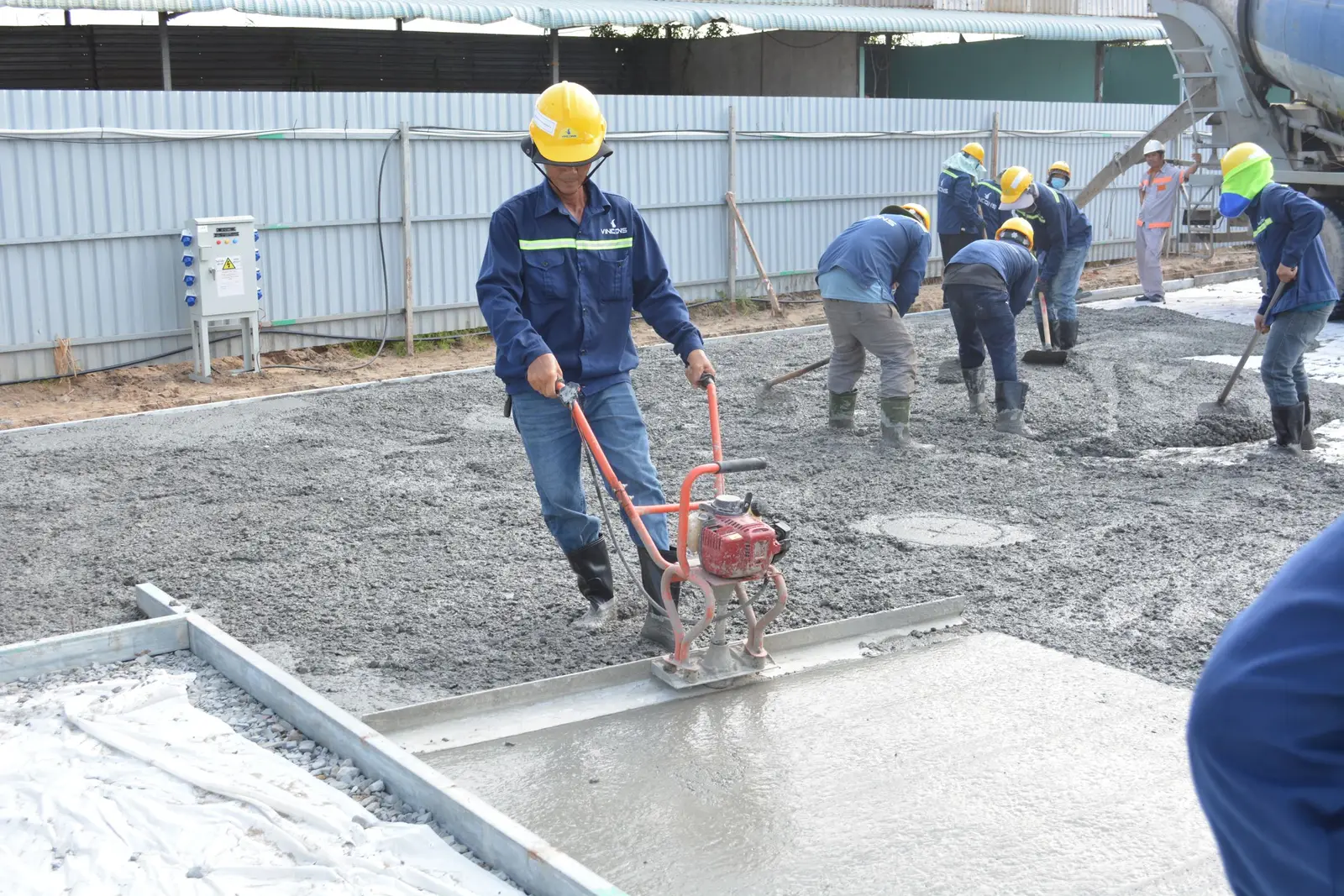 Concrete crew finishing a fresh slab pour on a mild morning in Cedar Hill, TX