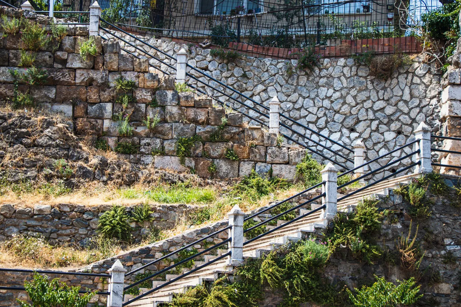 Poured concrete retaining wall holding a sloped escarpment lot in Cedar Hill, TX