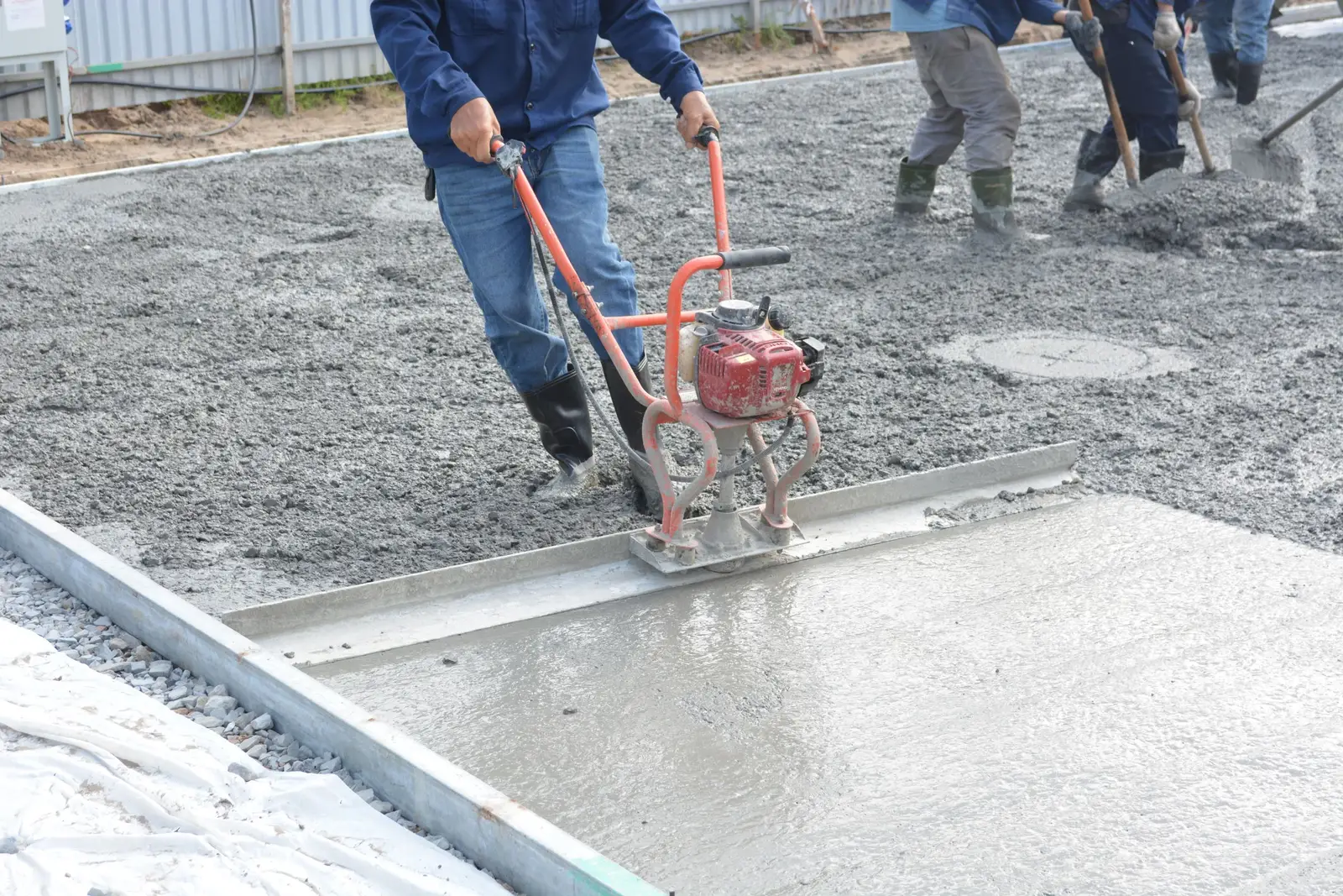 Formed and reinforced concrete slab pad ready for a workshop on a graded lot in Cedar Hill, TX