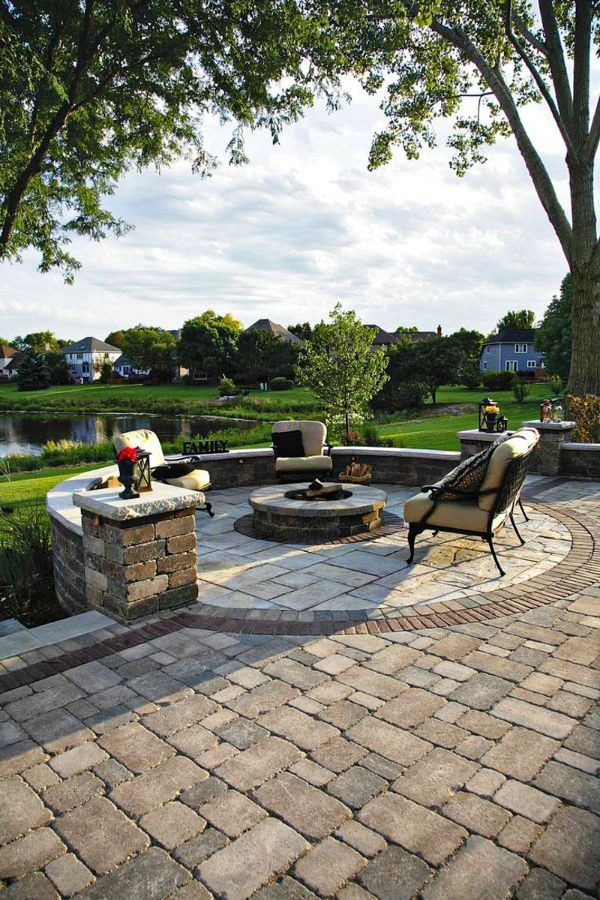 Elegant concrete patio in Cedar Hill TX with lakeside view, stone walls, and custom fire pit installation.